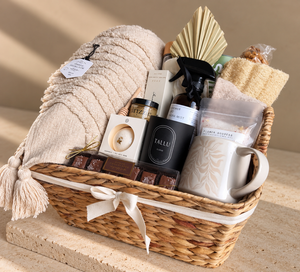 Luxury care package gift basket with cozy blanket, socks, candle, bath products, tea, mug and chocolates, thoughtfully curated with local Vancouver products.