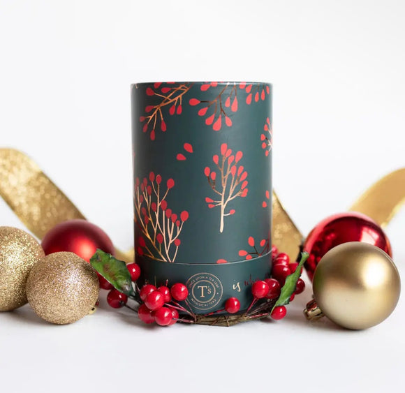 Holiday corporate gift box featuring Christmas tea, a ribbed ceramic mug, artisan chocolates, and a candle, styled with evergreen accents and brown ribbon in a black gift box.