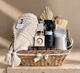 Luxury care package gift basket with cozy blanket, socks, candle, bath products, tea, mug and chocolates, thoughtfully curated with local Vancouver products.