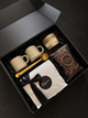 The Morning Ritual coffee gift box featuring artisan Artigiano coffee, two ceramic mugs, a gold coffee scoop, a scented candle, and Annie’s chocolate pretzels in a black gift box with black crinkle filler. corporate gifting vancouver. holiday gift.