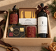 holiday local Christmas gift box with red wine, local chocolates, charcuterie knives, hand poured local candle and soap, client gifting
