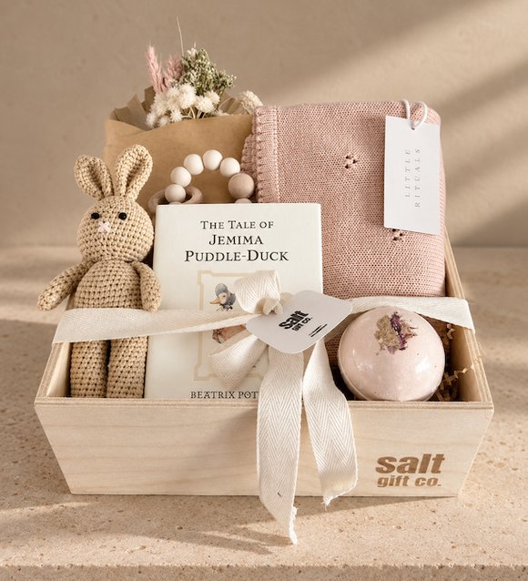 Vancouver baby girl gift box with knitted bunny, Beatrix Potter book, blue baby blanket and curated newborn gifts.