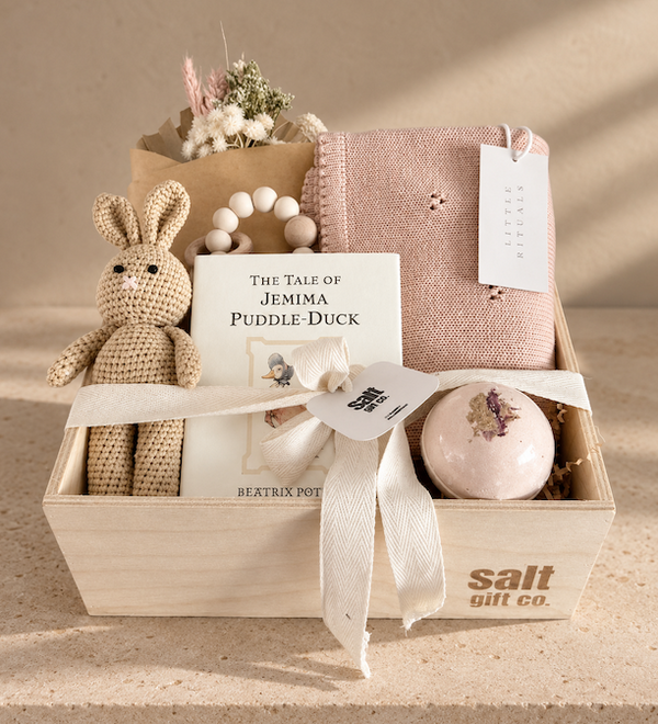 Vancouver baby girl gift box with knitted bunny, Beatrix Potter book, blue baby blanket and curated newborn gifts.